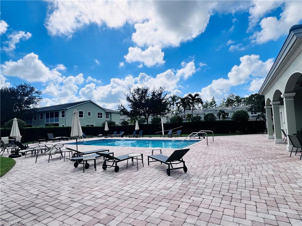 1435 Mariposa Circle, Unit 102 Naples, FL 34105 - Photo 23 of 24 a view of a patio with a table and chairs