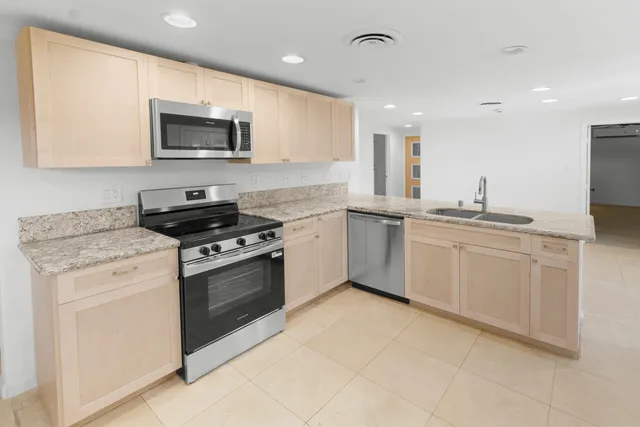 a kitchen with a sink stove and microwave
