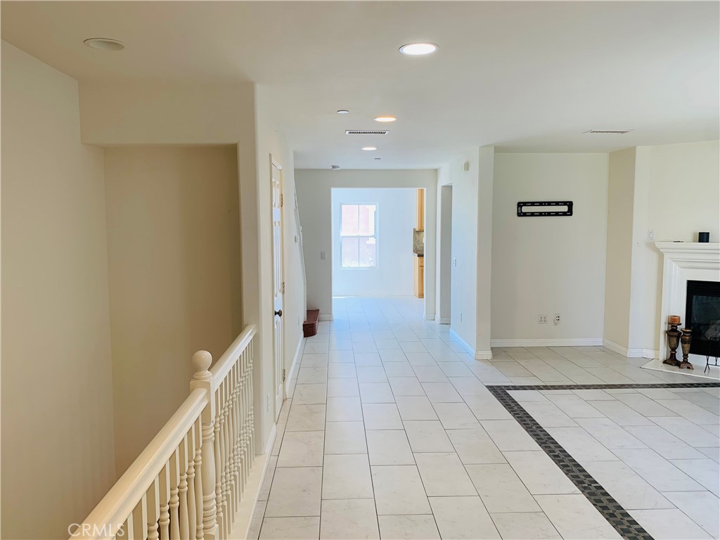 2813 Yacht Way Oxnard, CA 93035 - Photo 5 of 24 a view of a hallway with wooden floor and a living room