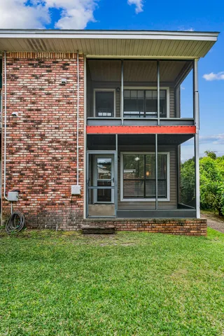 a view of brick house with a large window
