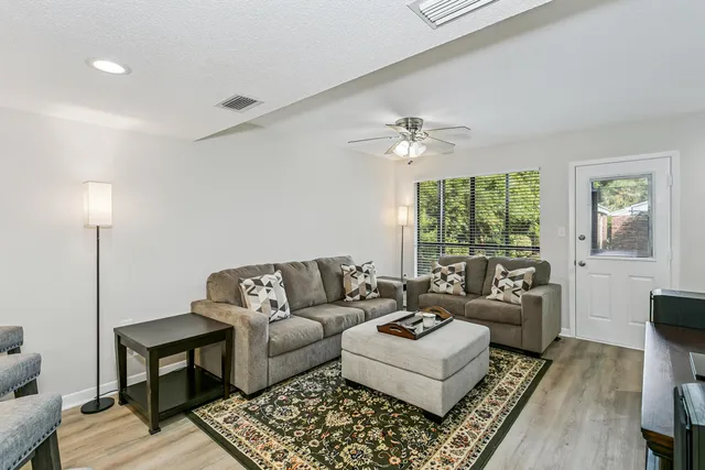 a living room with furniture and a large window