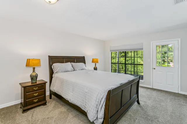 a bed sitting in a bedroom next to a window