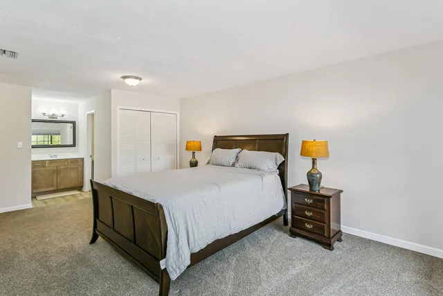 a bedroom with a bed and table