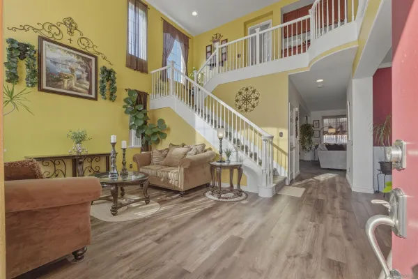 a view of entryway and hall with wooden floor
