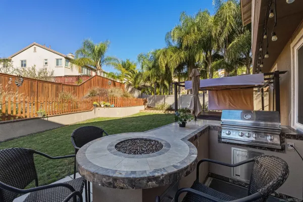 a front view of house along with deck and outdoor seating