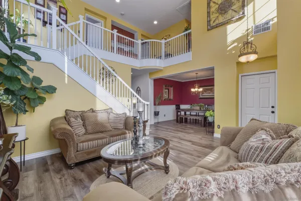 a living room with furniture and a potted plant