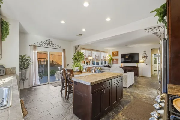 a large white kitchen with a large window and refrigerator