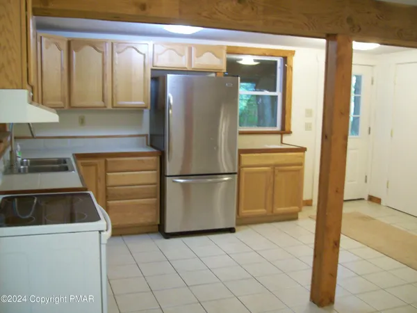 a kitchen with a refrigerator and a sink