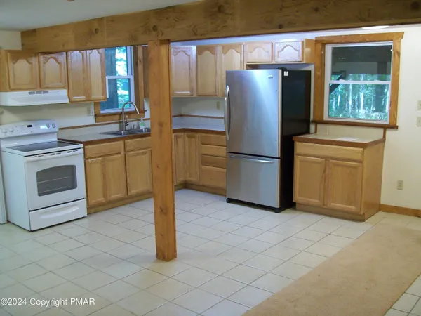 a kitchen with stainless steel appliances granite countertop a refrigerator sink and cabinets
