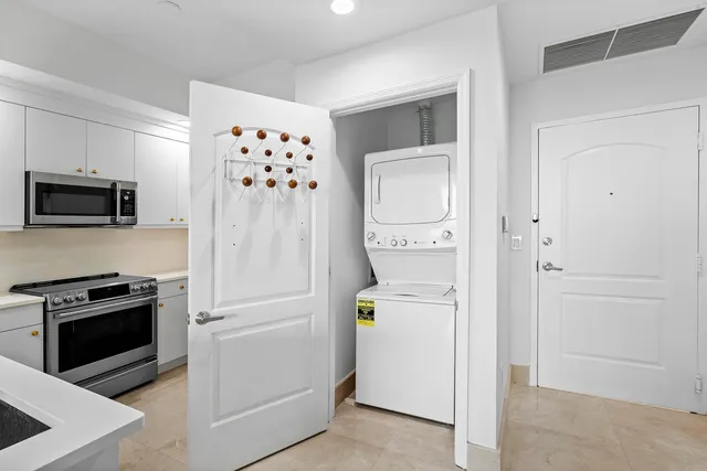 a kitchen with a refrigerator stove and white cabinets
