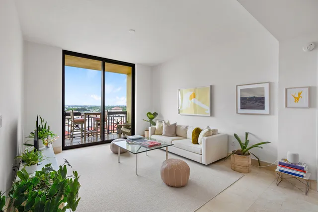 a living room with furniture and a potted plant