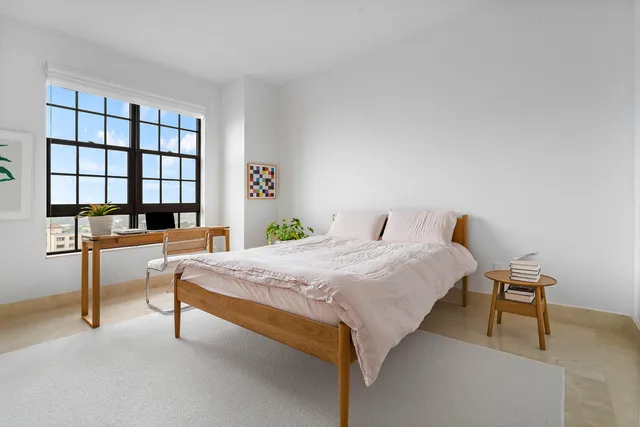 a bedroom with a bed and a desk