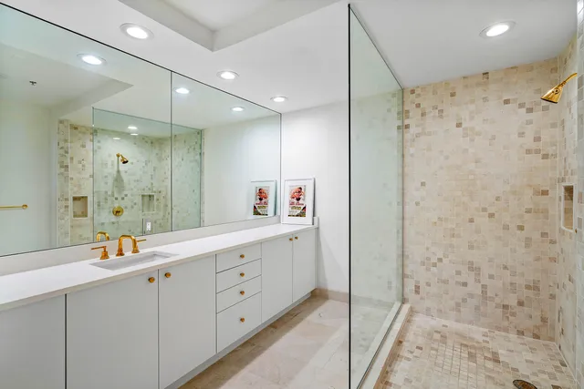 a bathroom with a double vanity sink mirror and shower