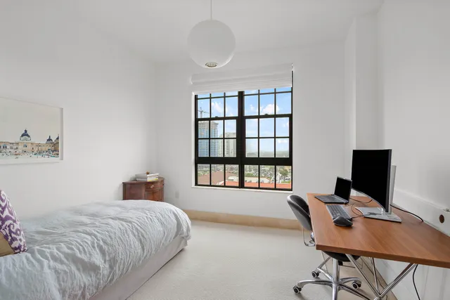 a bedroom with a workspace