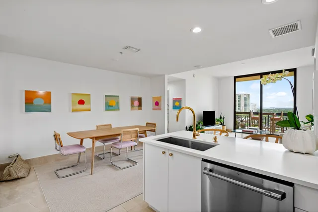 a work room with furniture a large window and a potted plant