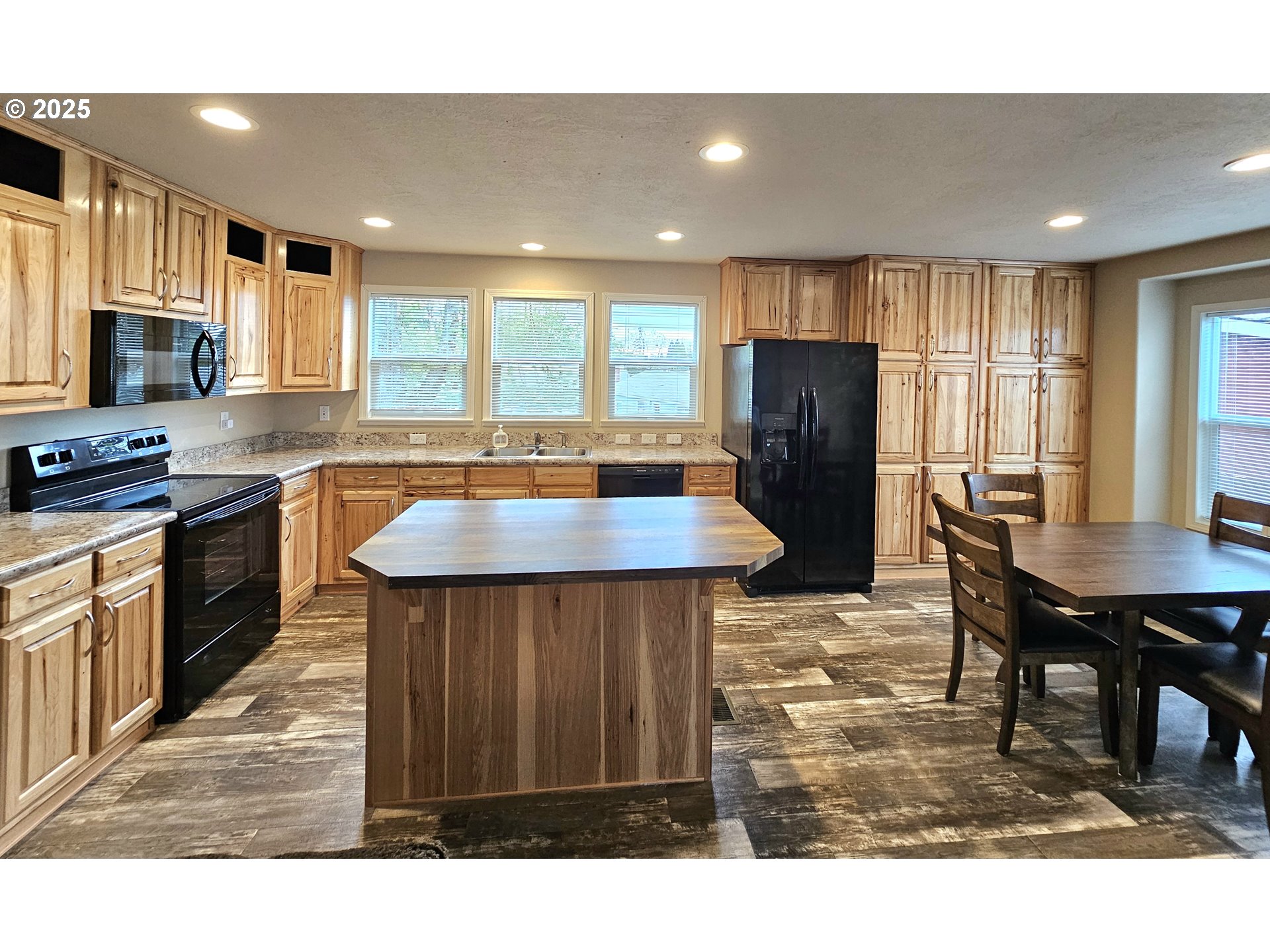 4675 Union Terrace Springfield, OR 97478 - Photo 8 of 37 a kitchen with stainless steel appliances granite countertop a table chairs and a refrigerator