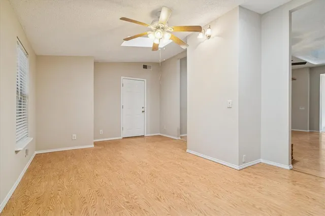 a view of a big room with closet and a chandelier fan