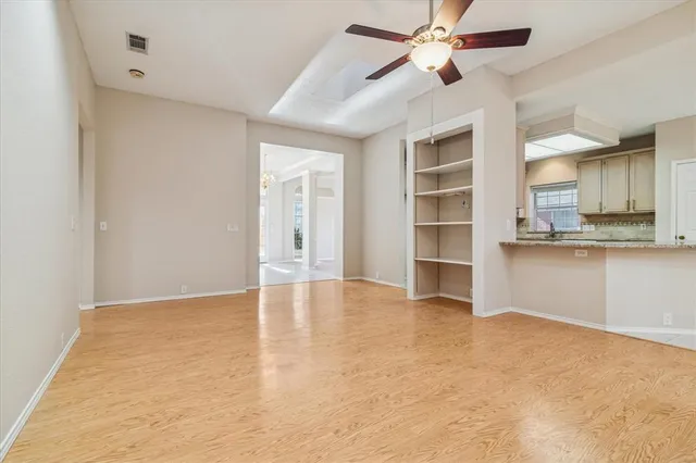a view of an empty room with a kitchen