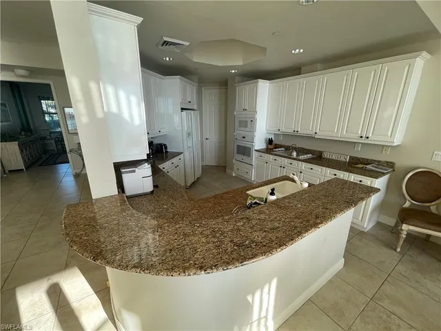 a view of a dining room with furniture and a large window