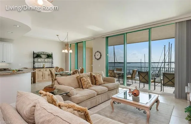 a living room with furniture kitchen and a chandelier