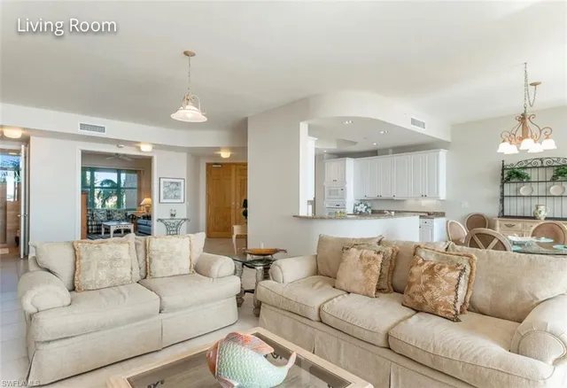 a living room with furniture and a floor to ceiling window