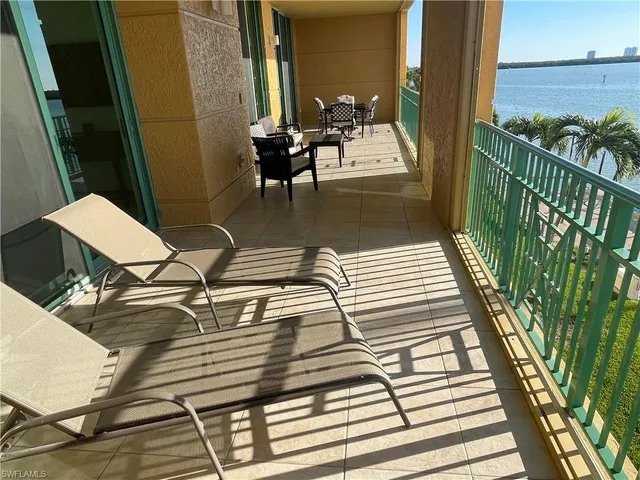 a balcony with table and chairs