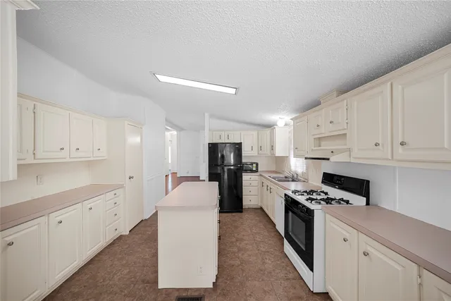 a kitchen with cabinets and stainless steel appliances