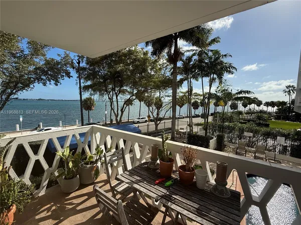 a view of a roof deck with couches and wooden floor