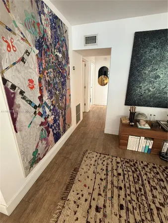wooden floor with a rug and a window