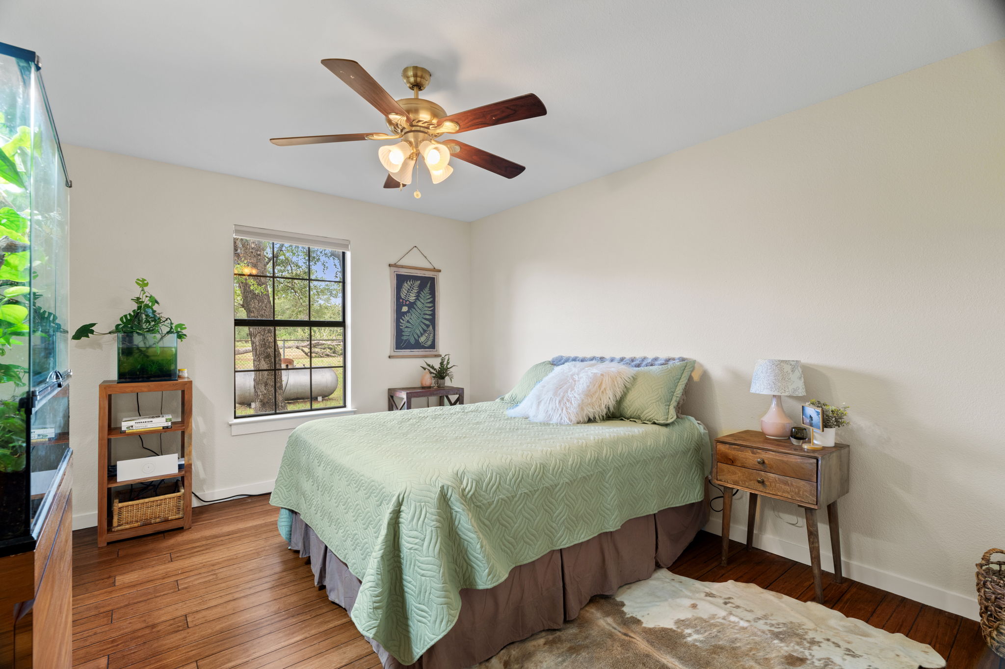 3434 Prairie-Lea Road Kingsbury, TX 78638 - Photo 17 of 38 a bedroom with a bed and wooden floor