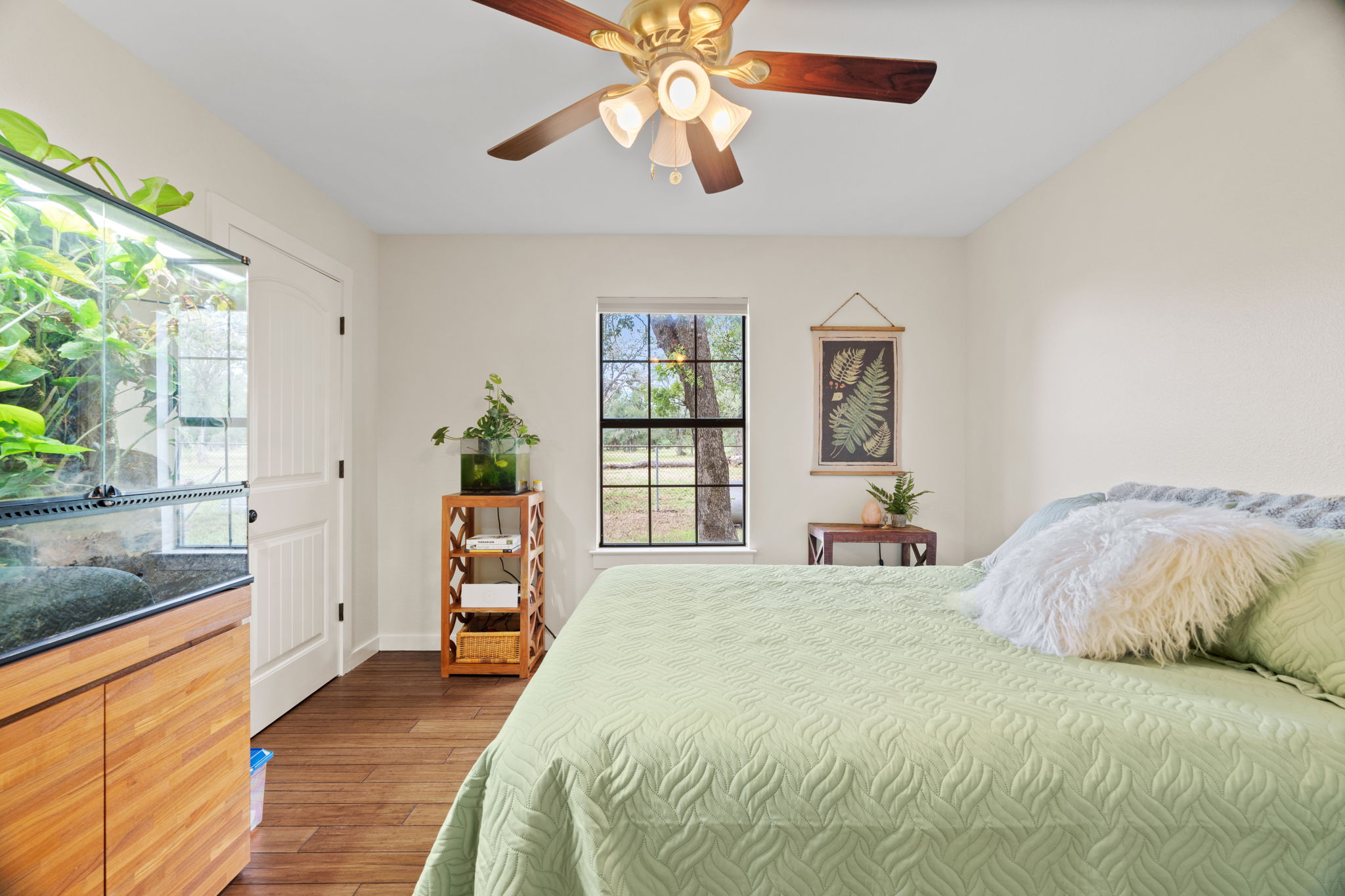 3434 Prairie-Lea Road Kingsbury, TX 78638 - Photo 18 of 38 a bedroom with a large bed and a chandelier
