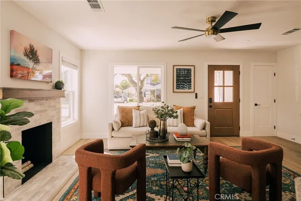 a living room with furniture a fireplace and a flat screen tv