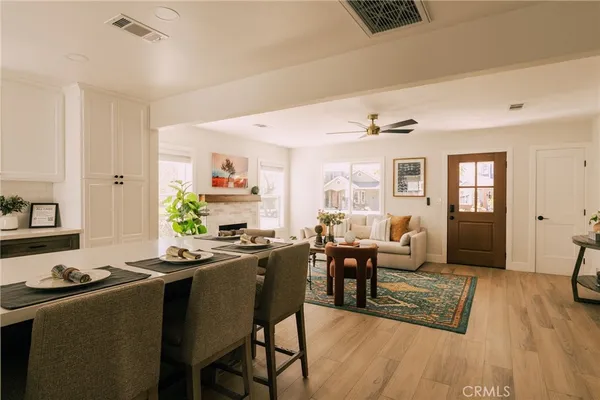 a living room with furniture dining table and a wooden floor