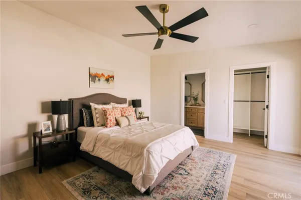 a bedroom with a bed and wooden floor