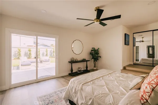 a bedroom with a large bed and a chandelier
