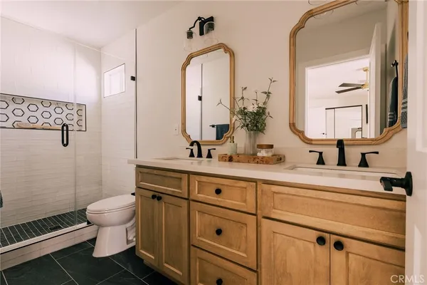 a bathroom with a sink a toilet and a mirror