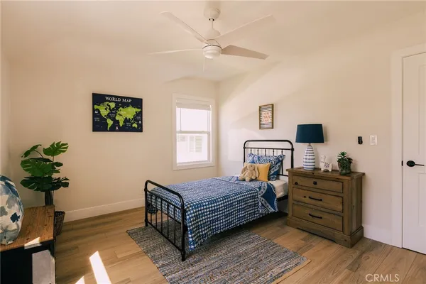 a bedroom with a bed and wooden floor
