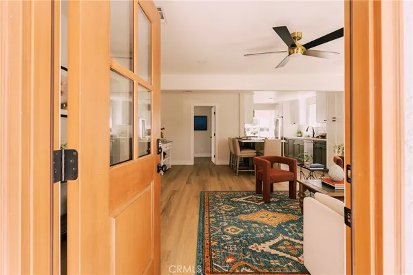 a living room with furniture a ceiling fan and a window