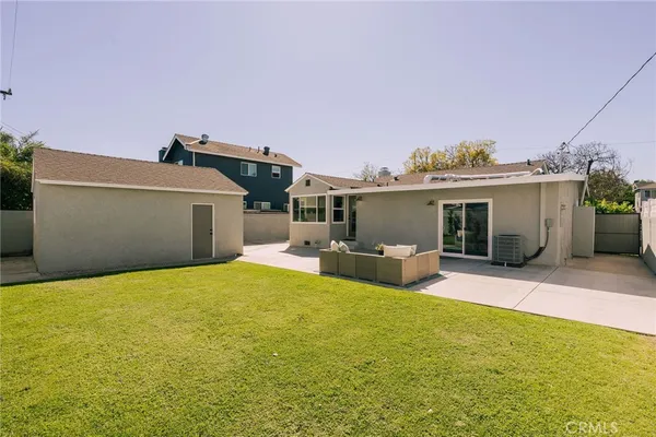 a view of a house with swimming pool and sitting area