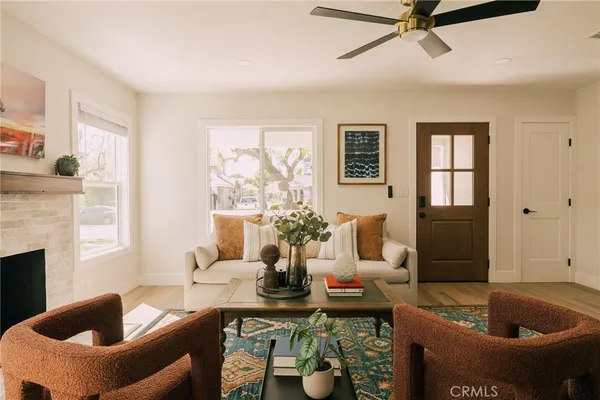 a living room with furniture and a potted plant