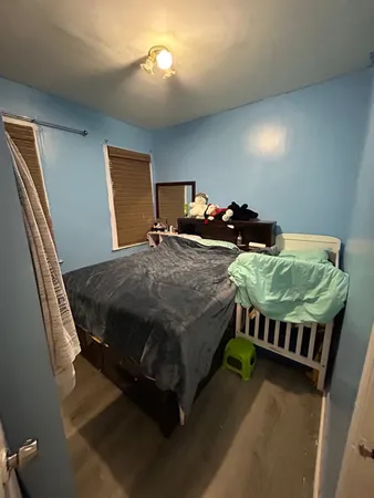 a bedroom with bed and a window