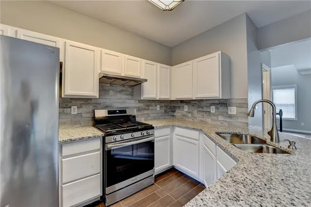 a kitchen with a stove microwave and sink