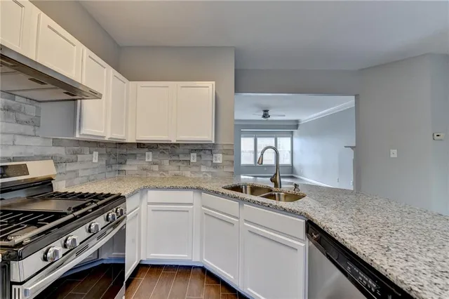 a kitchen with a sink stove and cabinets