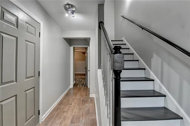 a view of entryway and gallery with wooden floor