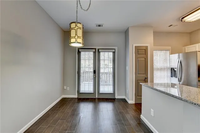 a view of a room with wooden floor and windows