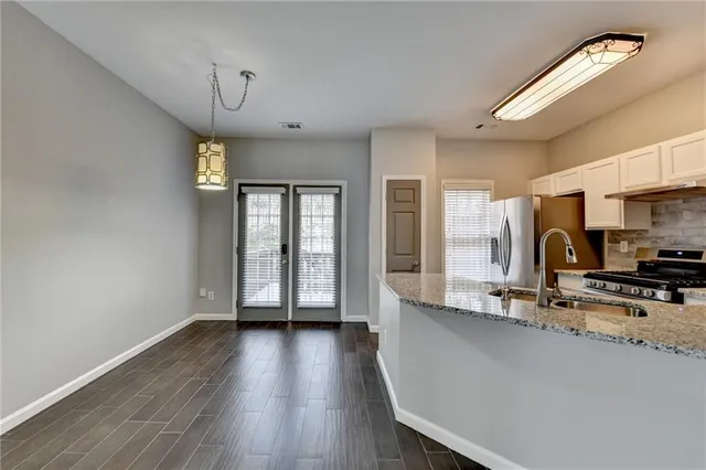 a view of kitchen with furniture and wooden floor