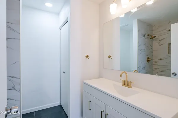 a bathroom with a sink and a large mirror