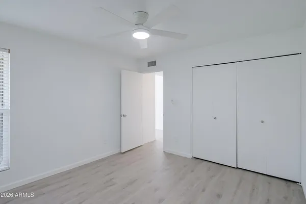 a view of an empty room with wooden floor