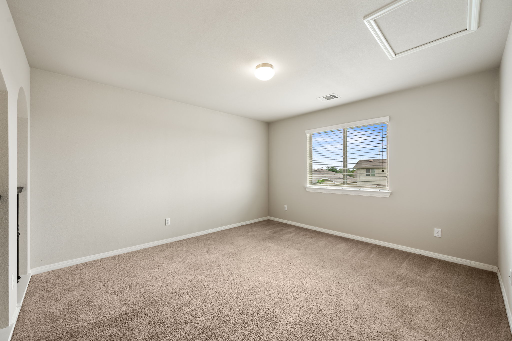 12701 Carillon Way Manor, TX 78653 - Photo 13 of 20 Neutral-toned walls and plush carpet flooring complement a window offering natural light