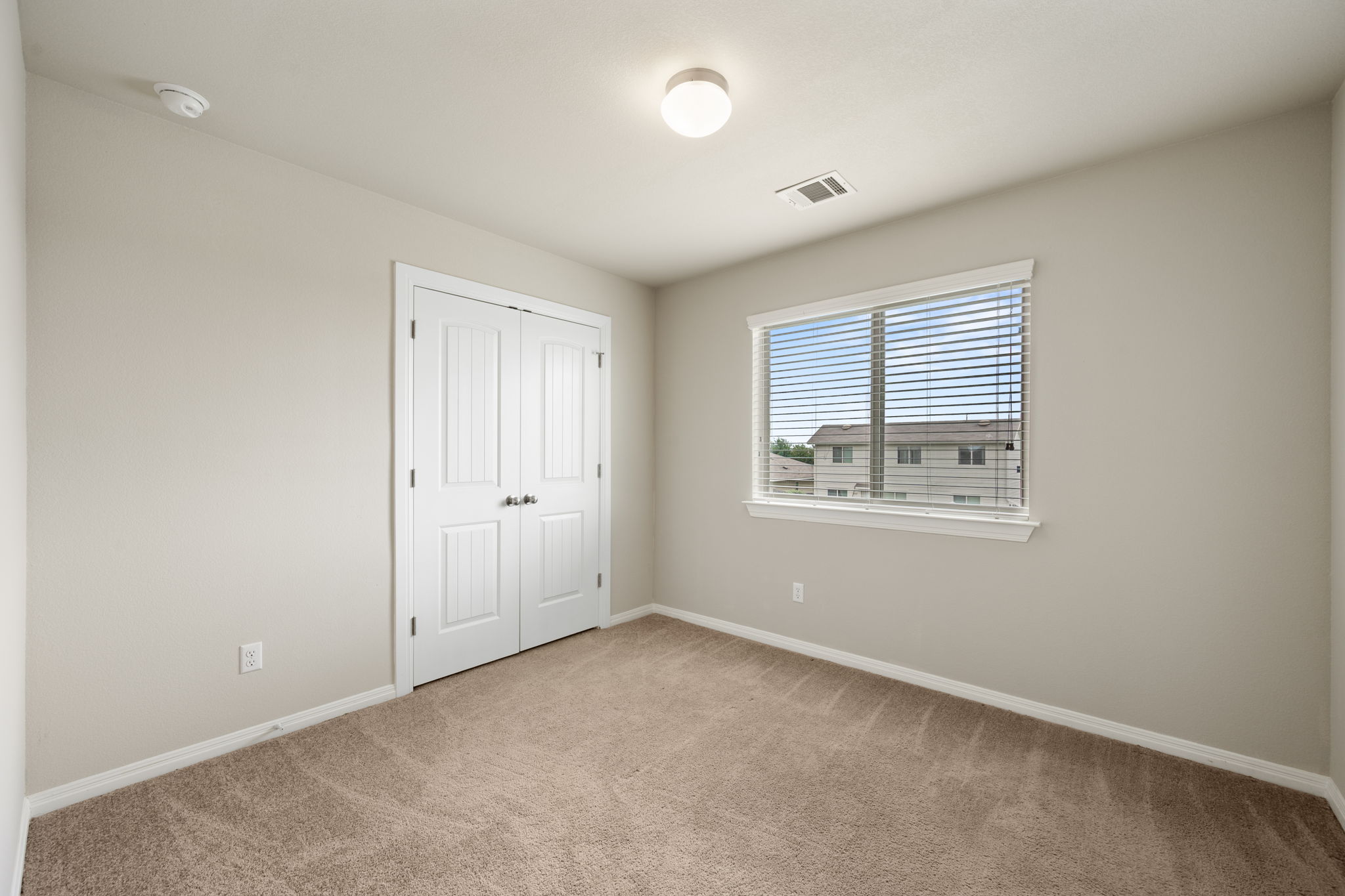 12701 Carillon Way Manor, TX 78653 - Photo 15 of 20 Neutral-toned room with plush carpeting and a double-door closet
